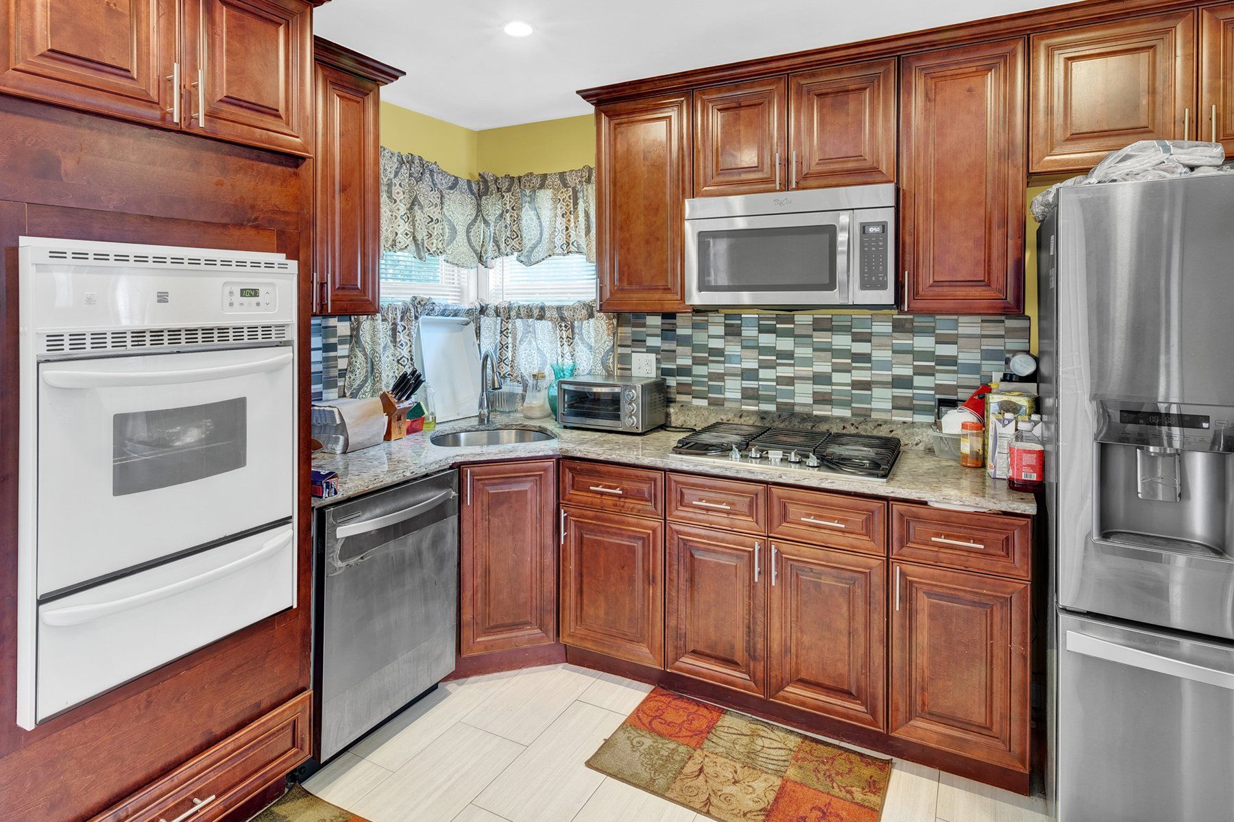 A kitchen with wooden cabinets and stainless steel appliances.