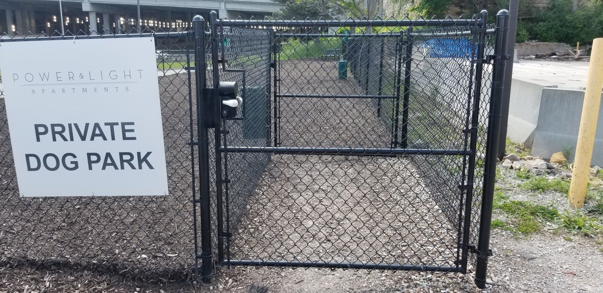 A private dog park is behind a chain link fence
