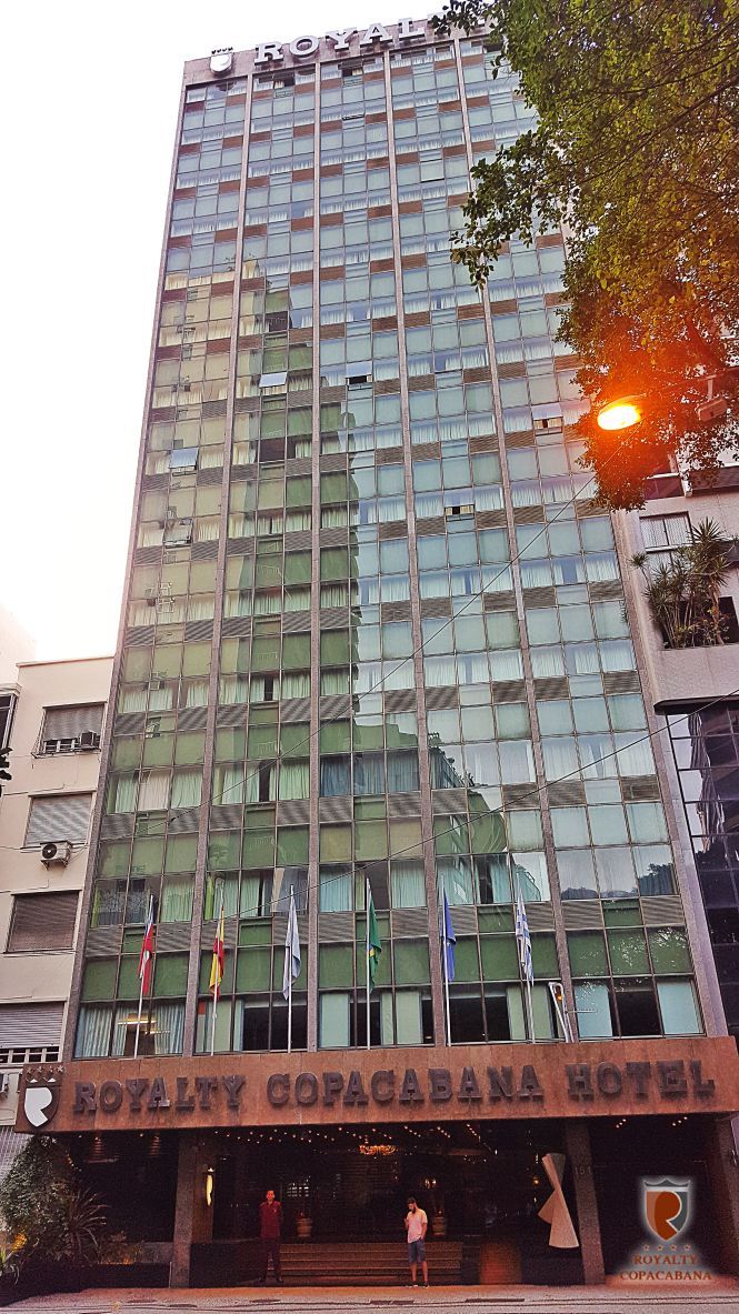 Um prédio alto com muitas janelas e uma placa que diz hotel copacabana.