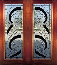 Pair of wooden doors with ornate frosted glass panels and black swirls.