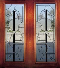 Wooden double doors with frosted glass panels and a central circular decorative design.