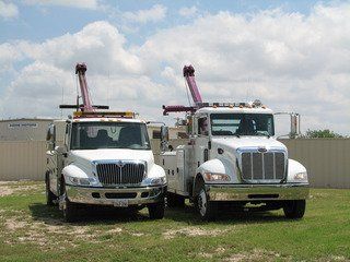 Two Home Motors, Inc tow truck service wreckers parked side by side