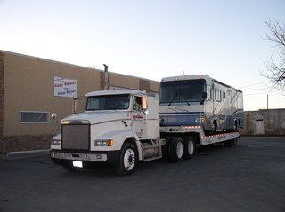 Tow truck service providing flatbed towing for a RV bus in San Angelo, TX