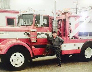Photo of Home Motors, Inc worker next to fleet vehicle