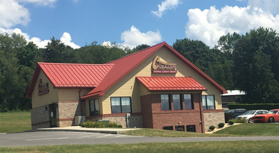 Multi-Level Office Space — White Commercial Building With Red Foundation in Marienville, PA