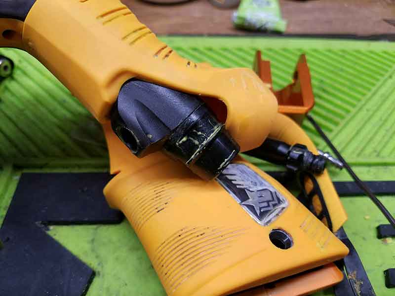 Yellow and black airsoft gun grip, with a black angled sight attachment.