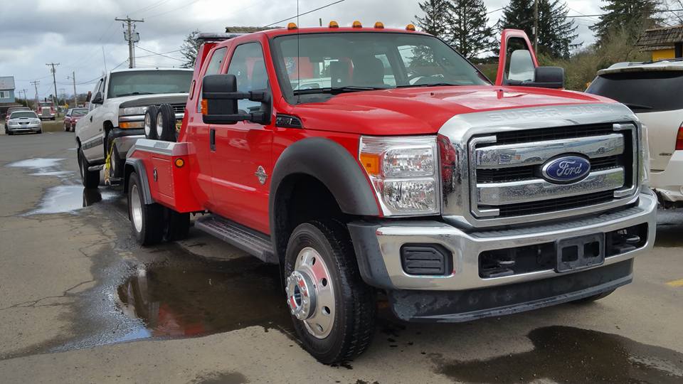 Red Wrecker with vehicle - Residential Towing in Astoria, OR Red Wrecker with vehicle - Residential Towing in Astoria, OR