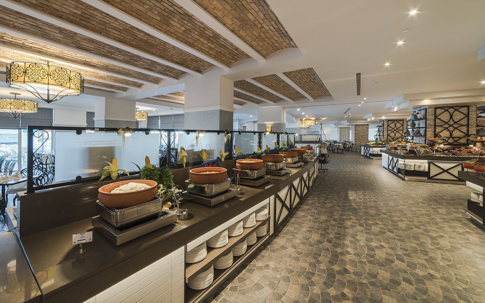 A buffet line in a restaurant with a lot of food on it.
