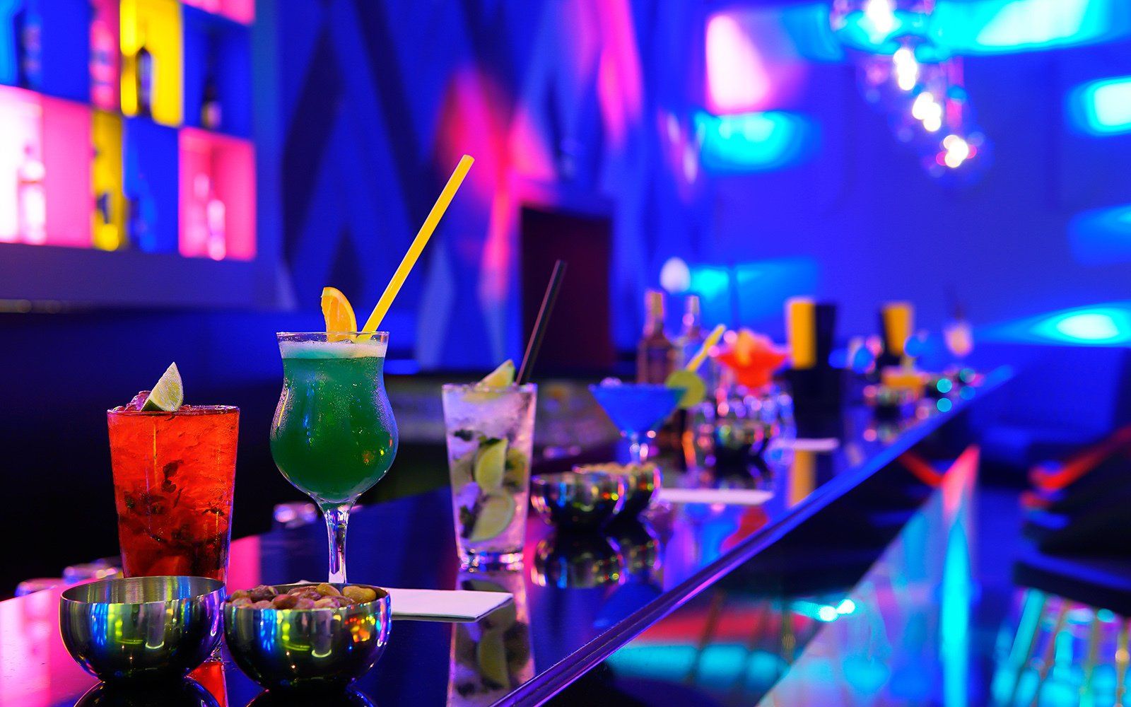 A bar with a lot of colorful drinks on it.