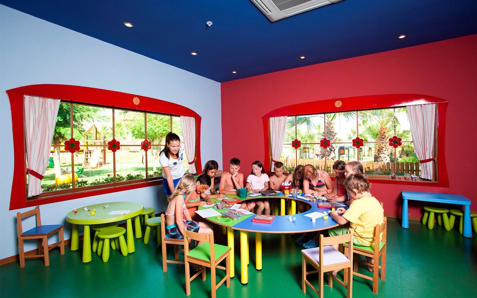 Eine Gruppe Kinder sitzt an Tischen in einem Klassenzimmer.