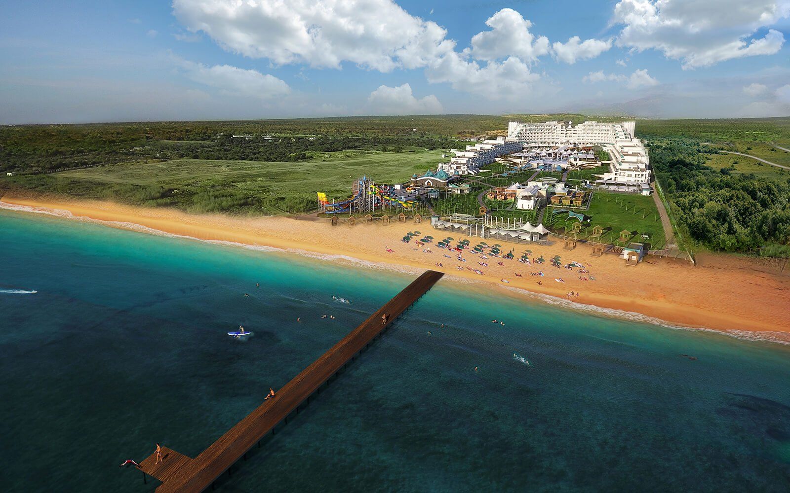 An aerial view of a beach with a pier leading to it.
