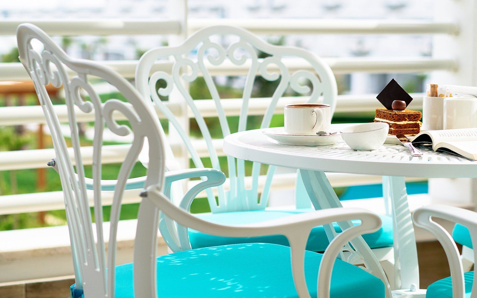 A table with a cup of coffee and a book on it.