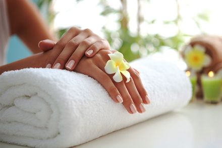 women in beauty salon with a flower in between her fingers