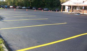 Paving contractor finishing new asphalt work for Batavia, NY