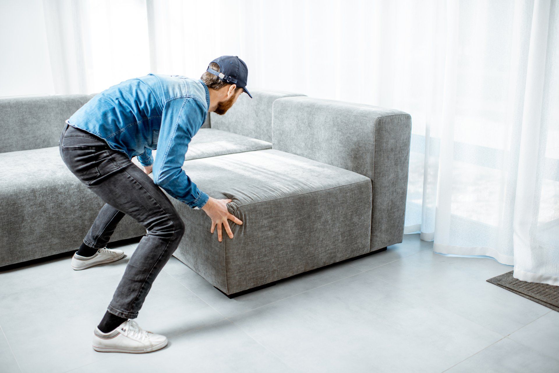 Furniture Delivery — Man Pushing Couch in Atlanta, GA Furniture Delivery — Man Pushing Couch in Atlanta, GA