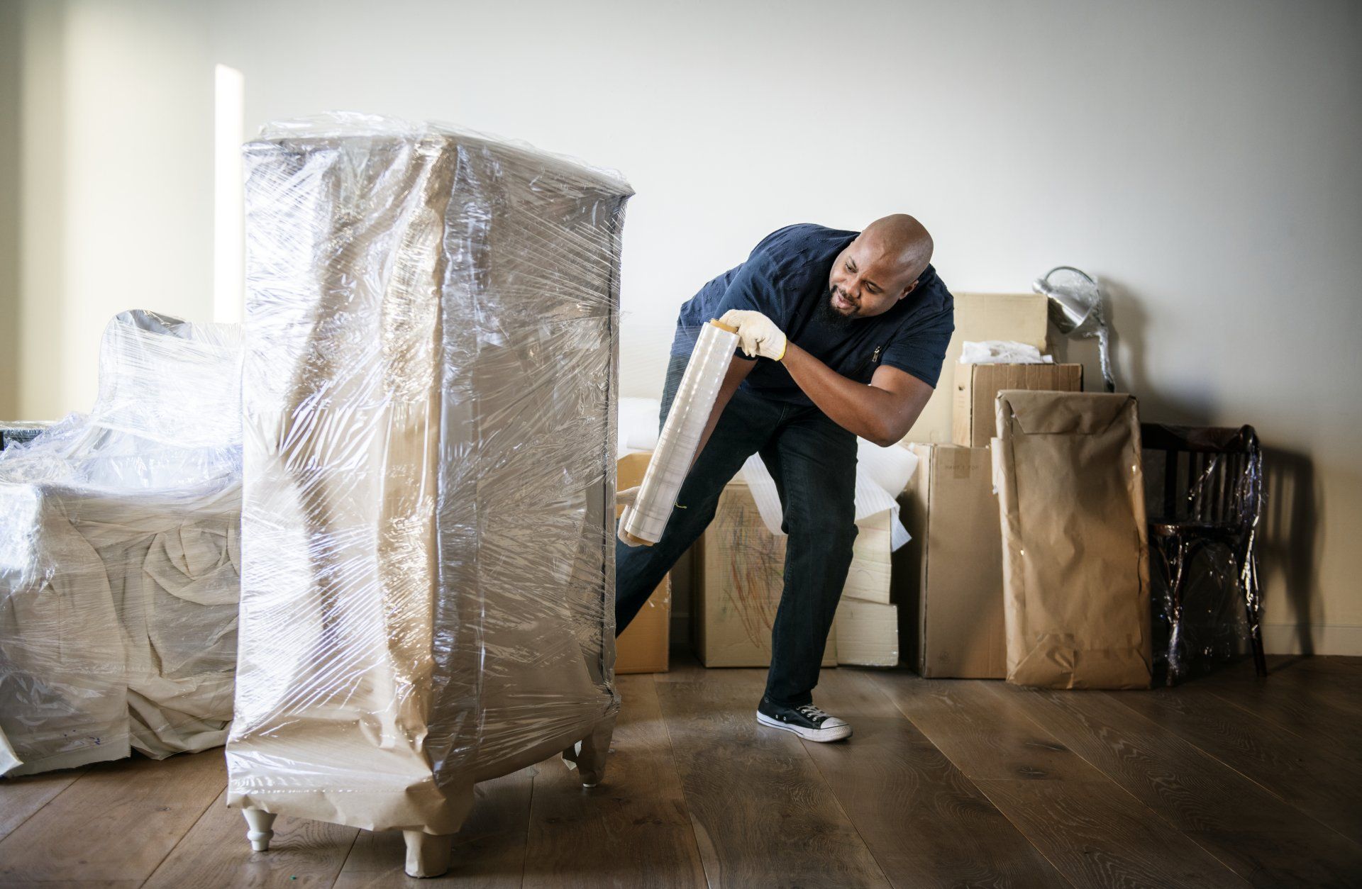 Warehouse — Man Wrapping A Furniture With Cling Film in Atlanta, GA