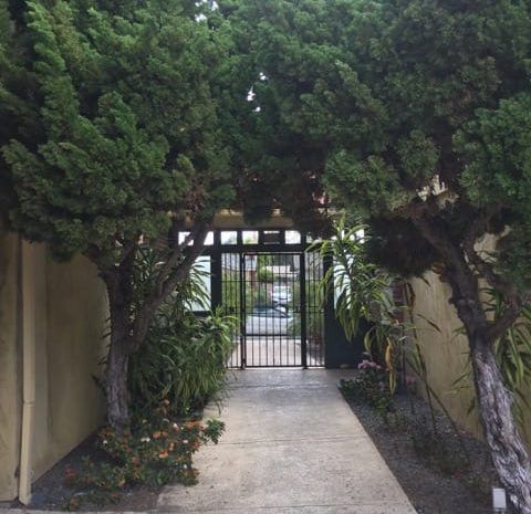 Gated entrance with landscaping on either side