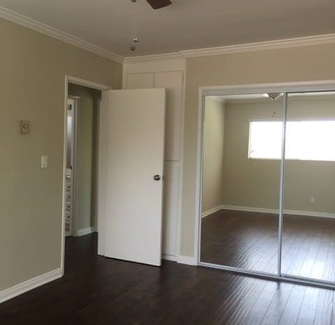 Bedroom with hardwood floors and a ceiling fan