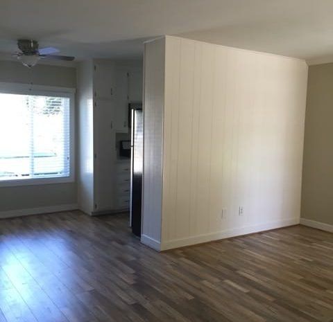 Apartment with hardwood floors and a ceiling fan