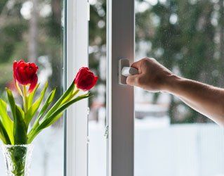 hand opening a window