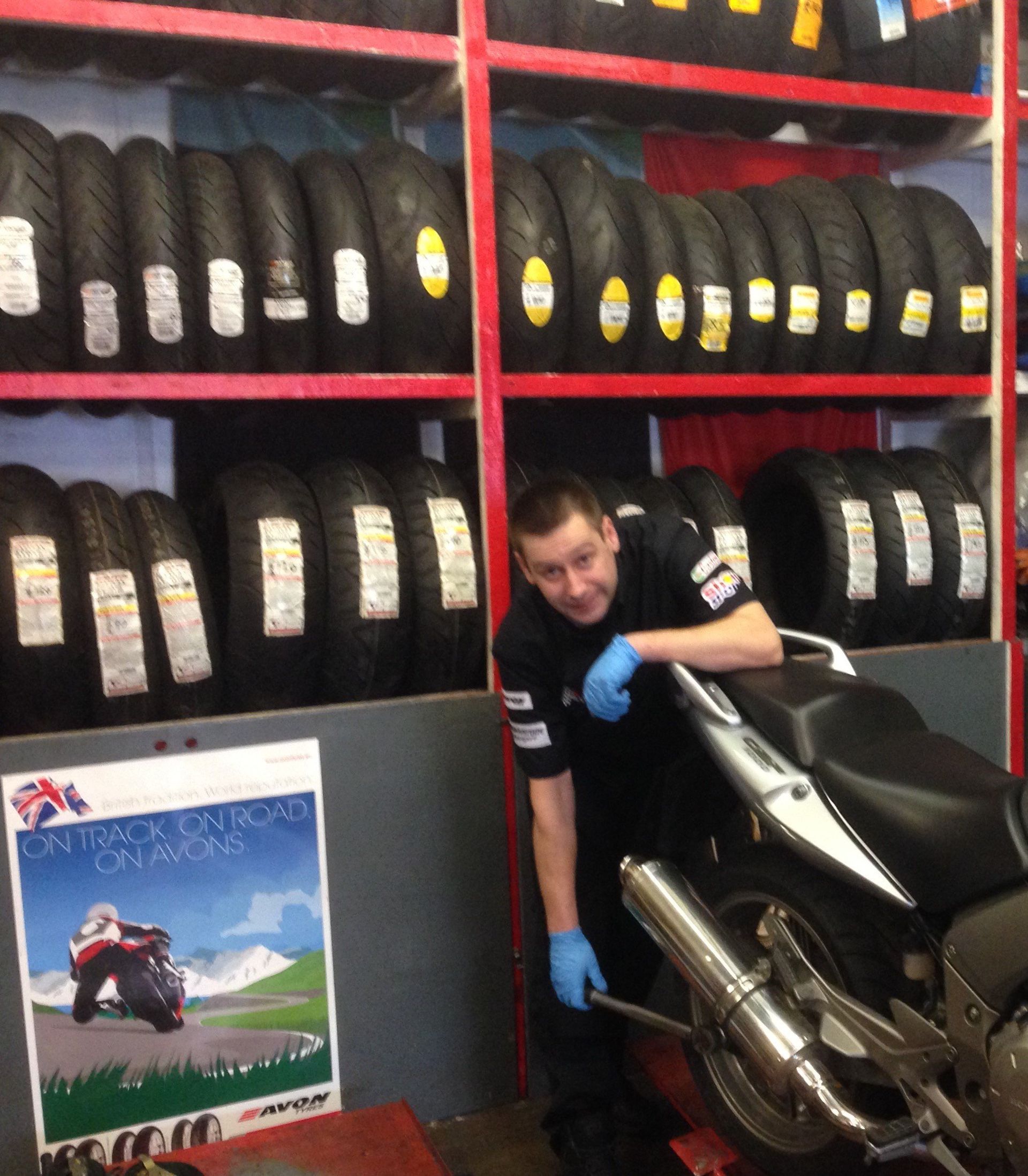 Our business owners sitting on motorbikes in the shop