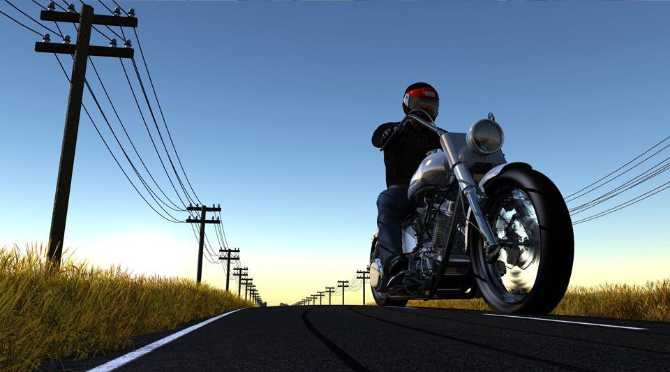A man on a motorbike travelling down a road
