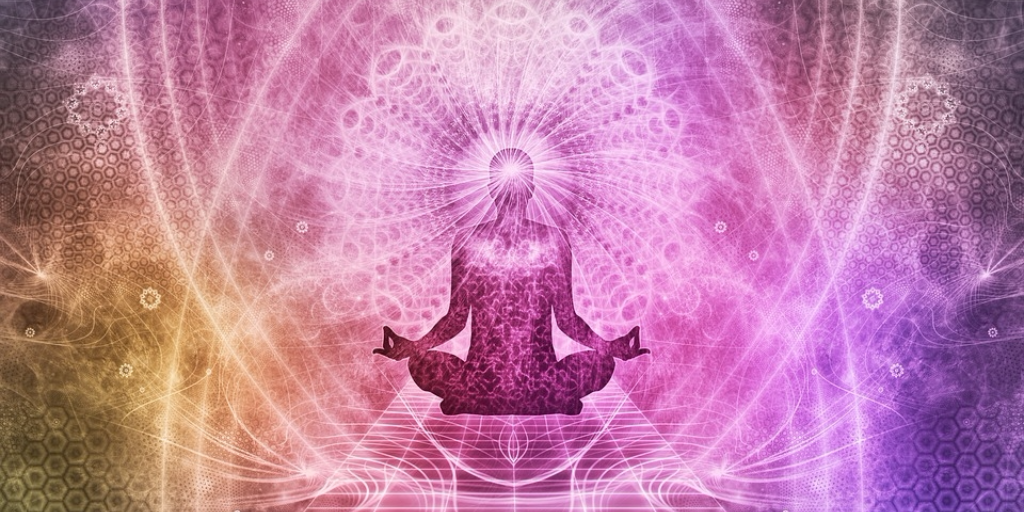 man meditating surrounded by neon lights