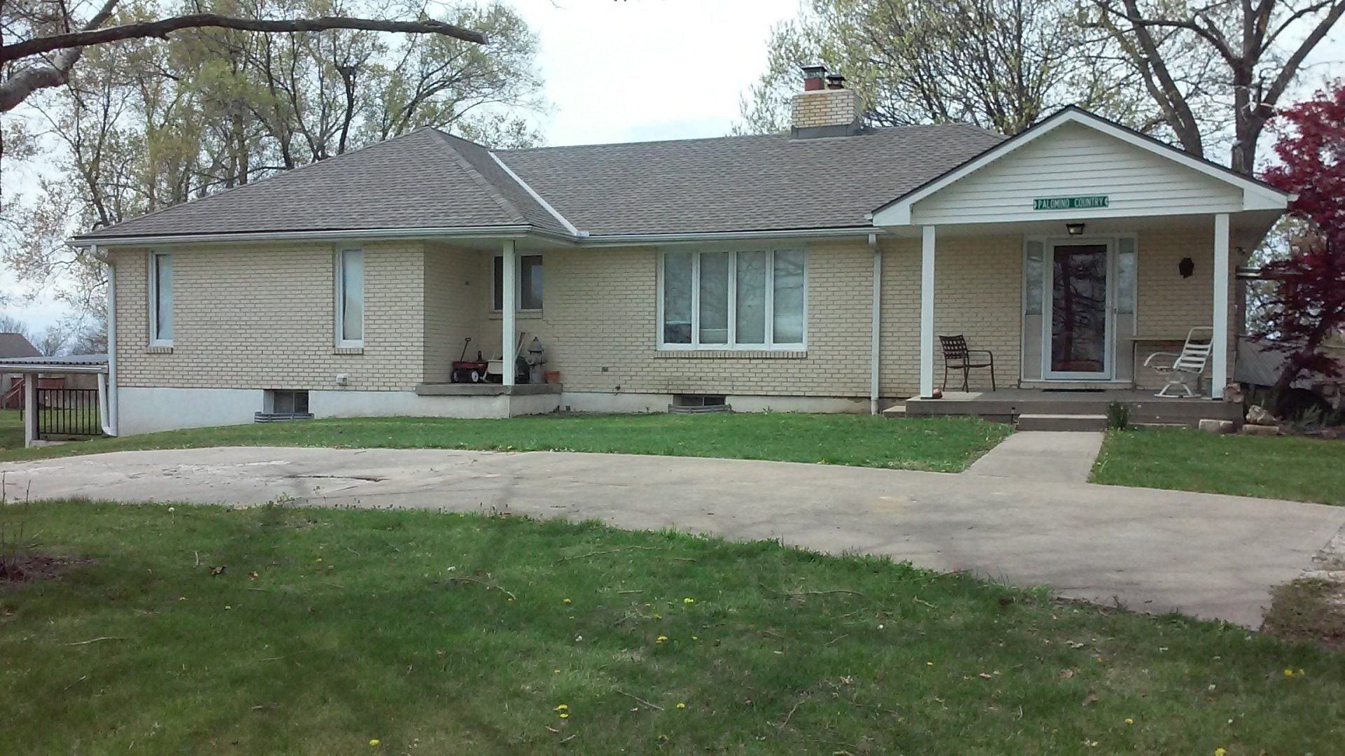 A house with a porch and a gray roof