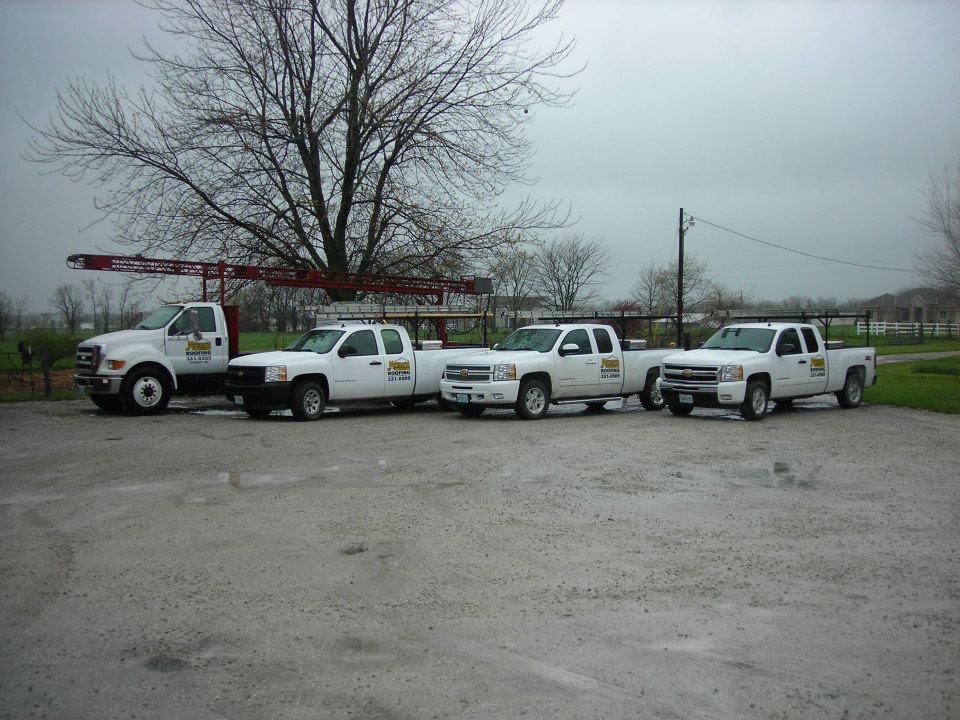 A row of white trucks parked in a parking lot