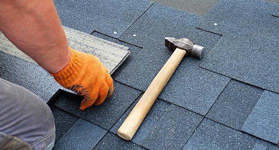 Contractor installing roof shingles — Raymore, MO — Meissen & Sons Roofing Contractor installing roof shingles — Raymore, MO — Meissen & Sons Roofing