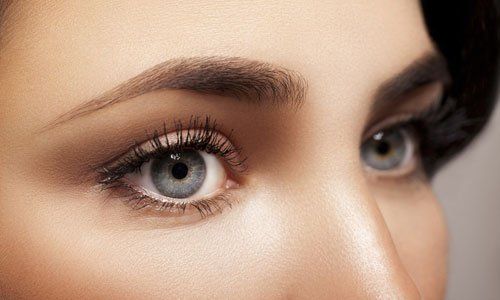 Close-up of eyes with neutral makeup and long lashes, showing a soft gaze