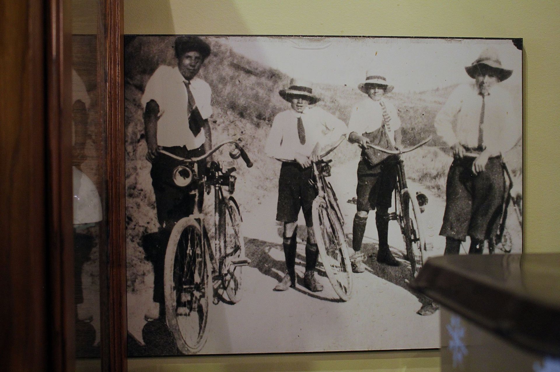 Historic black and white image of boys on bicycles