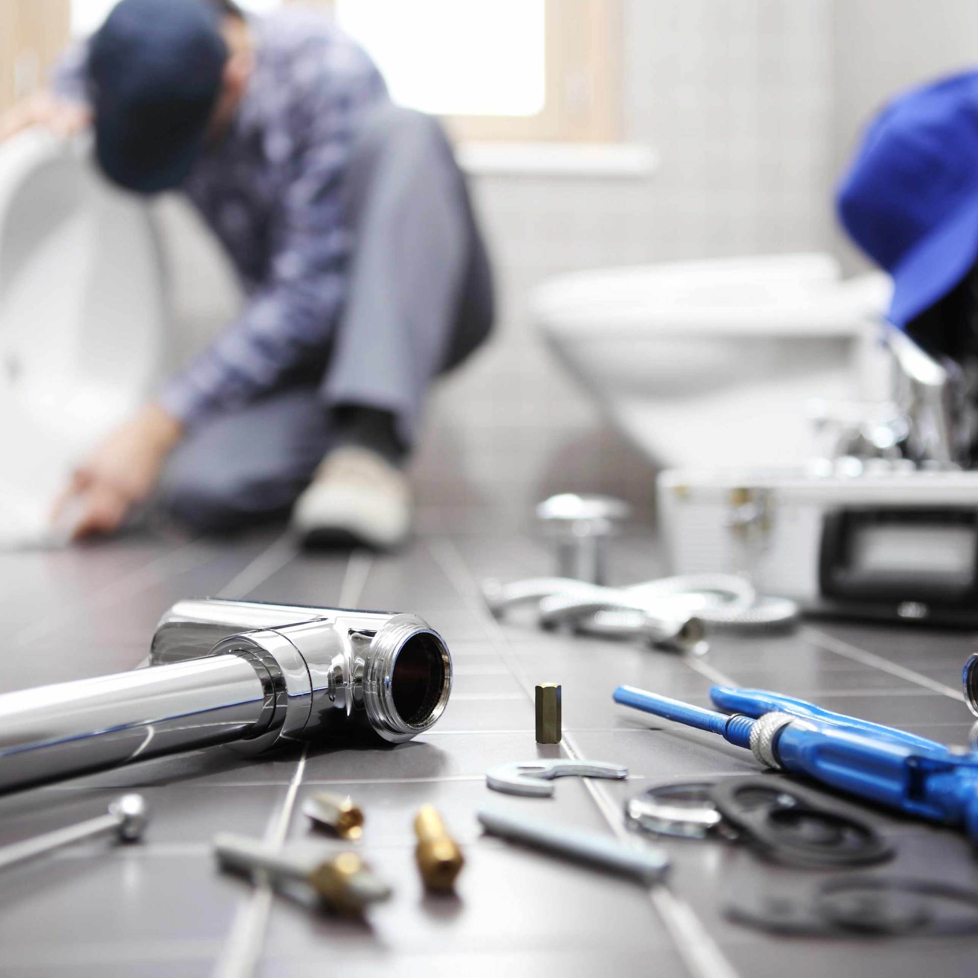 Plumber At Work In A Bathroom — Medford, OR — Cowboy Plumbing LLC Plumber At Work In A Bathroom — Medford, OR — Cowboy Plumbing LLC