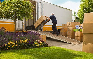 a person is moving the boxes into the truck.