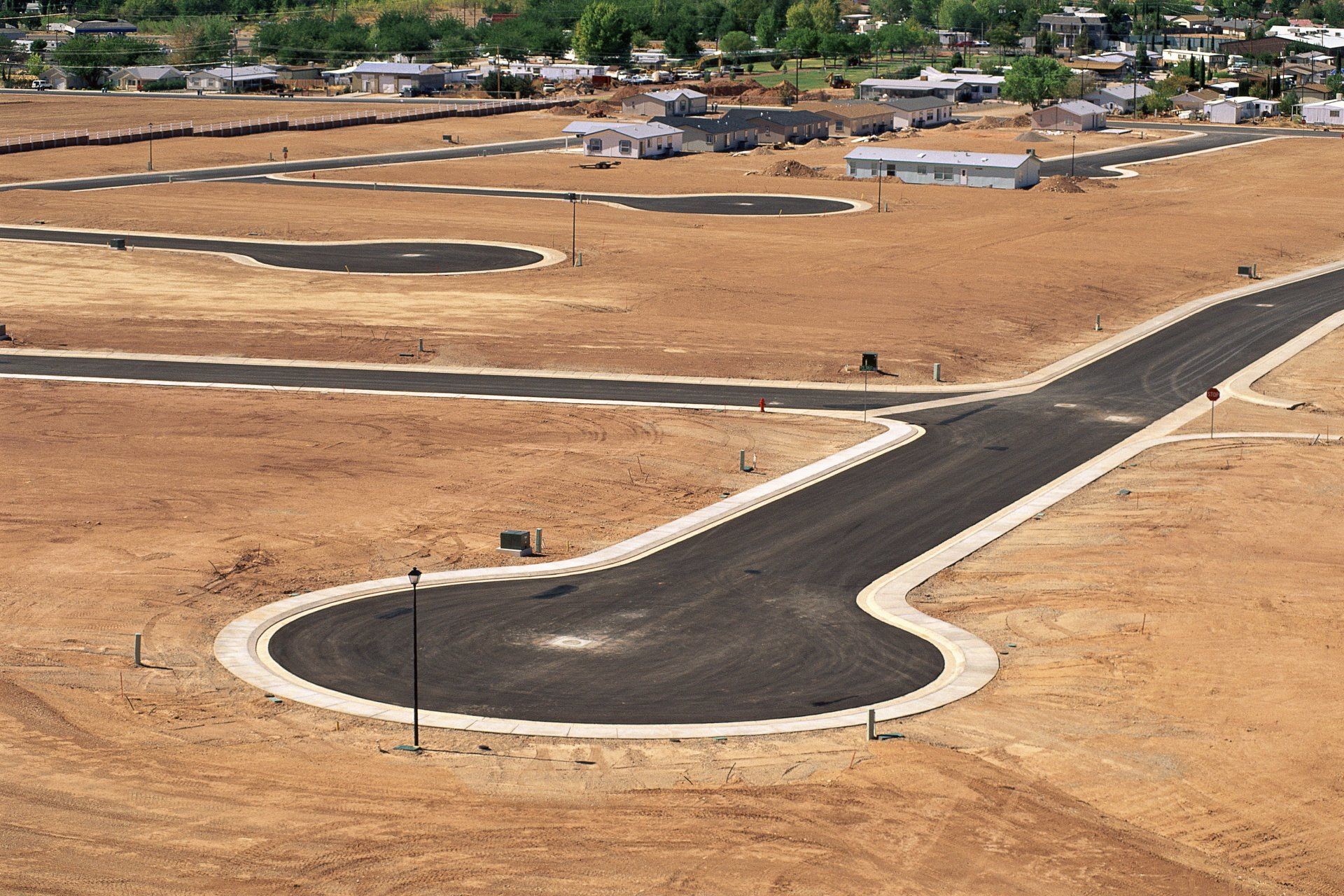 An aerial view of a residential area with a road going through it