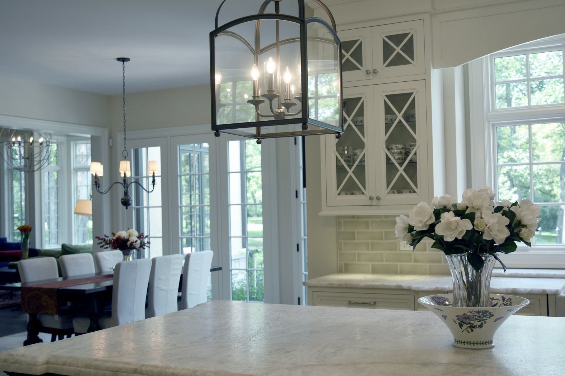 A kitchen counter with a vase of flowers on it