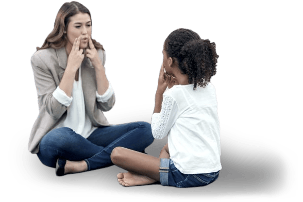A woman and a child are sitting on the floor talking to each other.