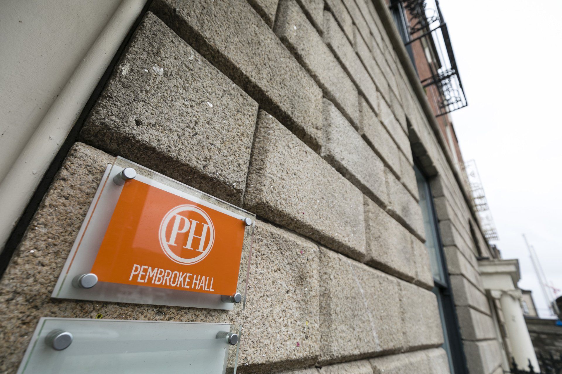 A sign on the side of a building that says ph