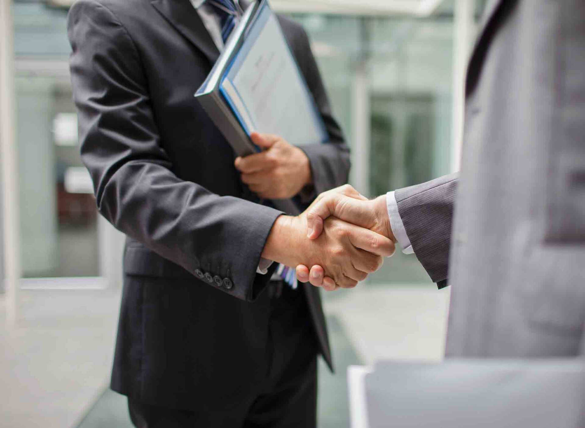 2 people shaking hands outdoors
