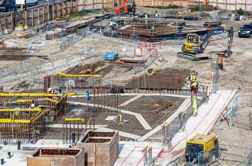 An aerial view of a construction site with workers and machinery.