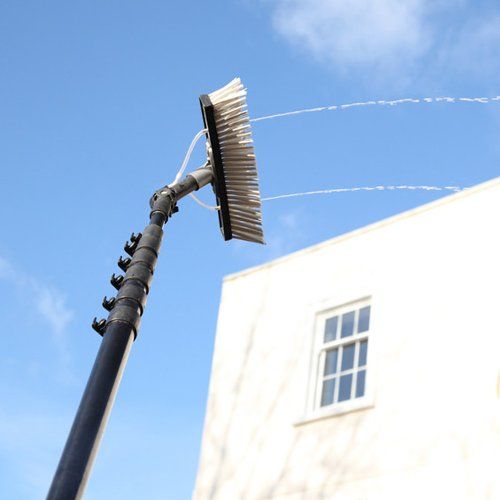 Window cleaning using the water fed pole system, also called reach and wash.
