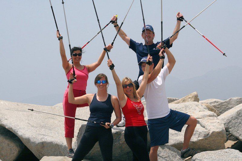 A group of people are posing for a picture with their arms in the air