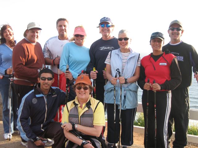 A group of people posing for a picture with walking poles