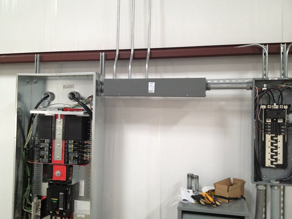 a large electrical box is hanging from the ceiling in a room .