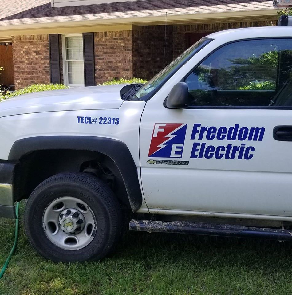 a freedom electric truck is parked in front of a house