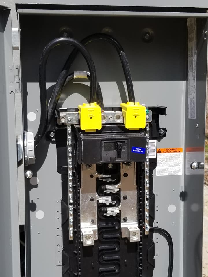 a close up of an electrical box with yellow clips on it