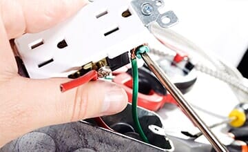 Electrician Repairing an Outlet — Electrical Services in Charlotte NC