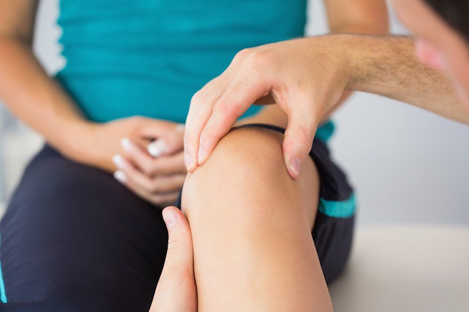 woman getting knee checked