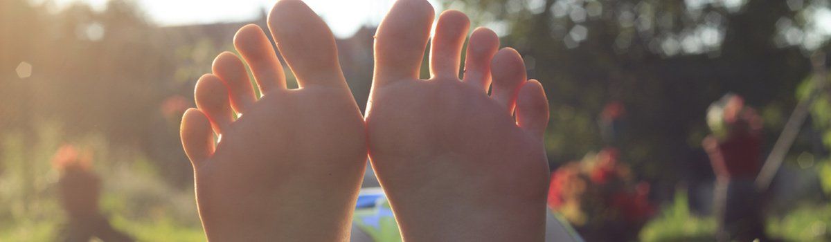 Orange podiatry service girl lying on grass Orange podiatry service girl lying on grass