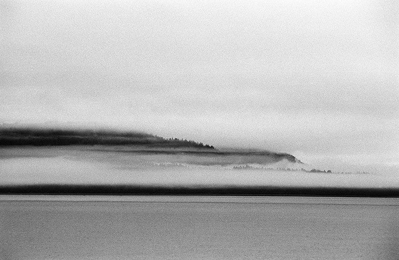 a documentary photo of mist, land and water in Alaska.